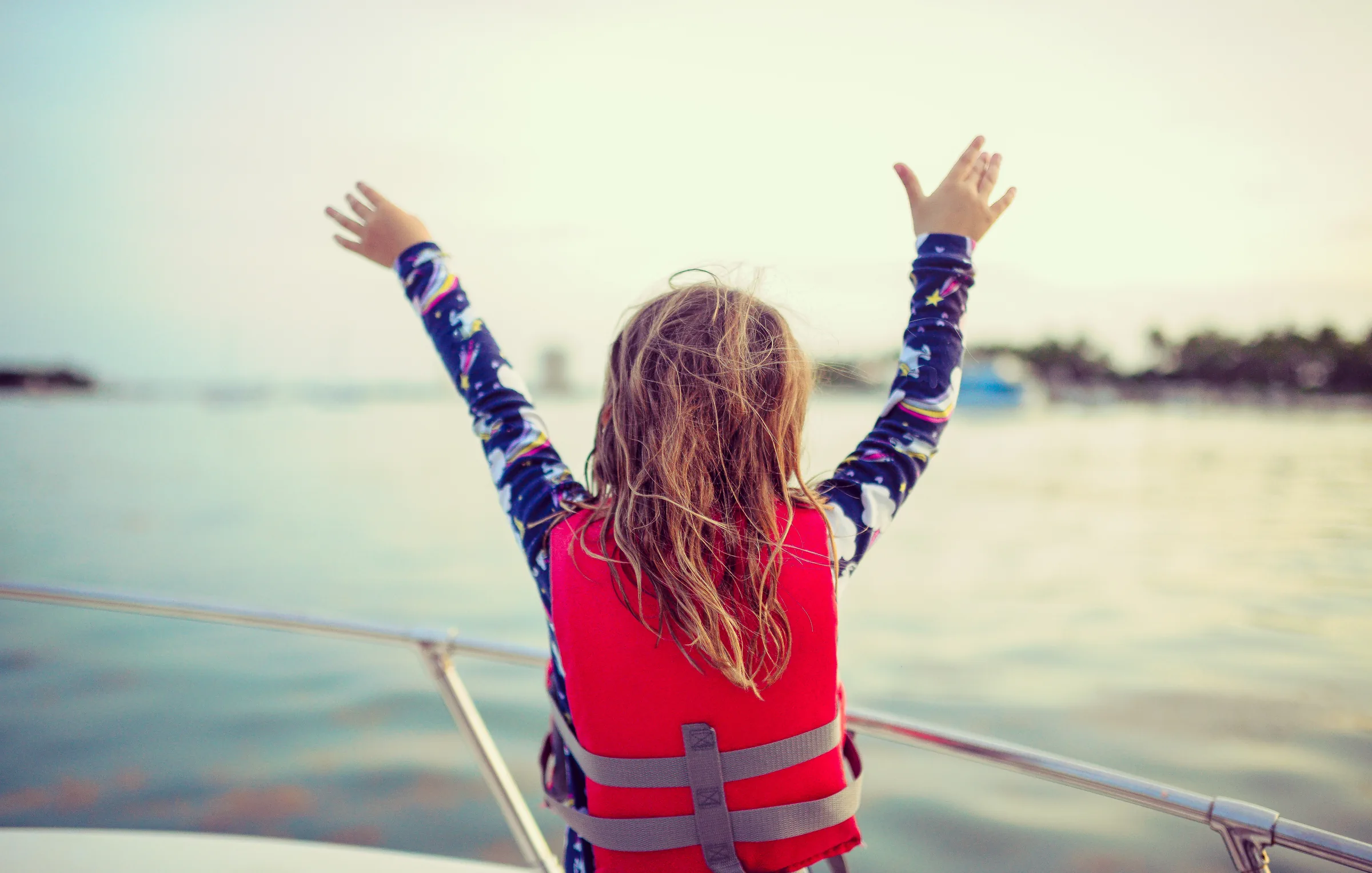 Child on a boat looking out at the water